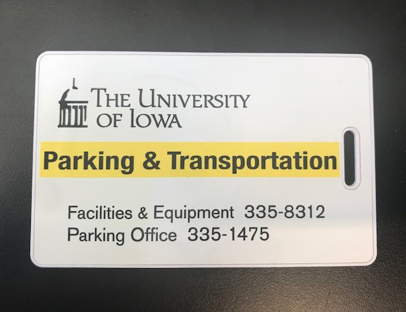 white access card on black background with graphic on card in gold and black reading University of Iowa Parking and Transportation and department phone number