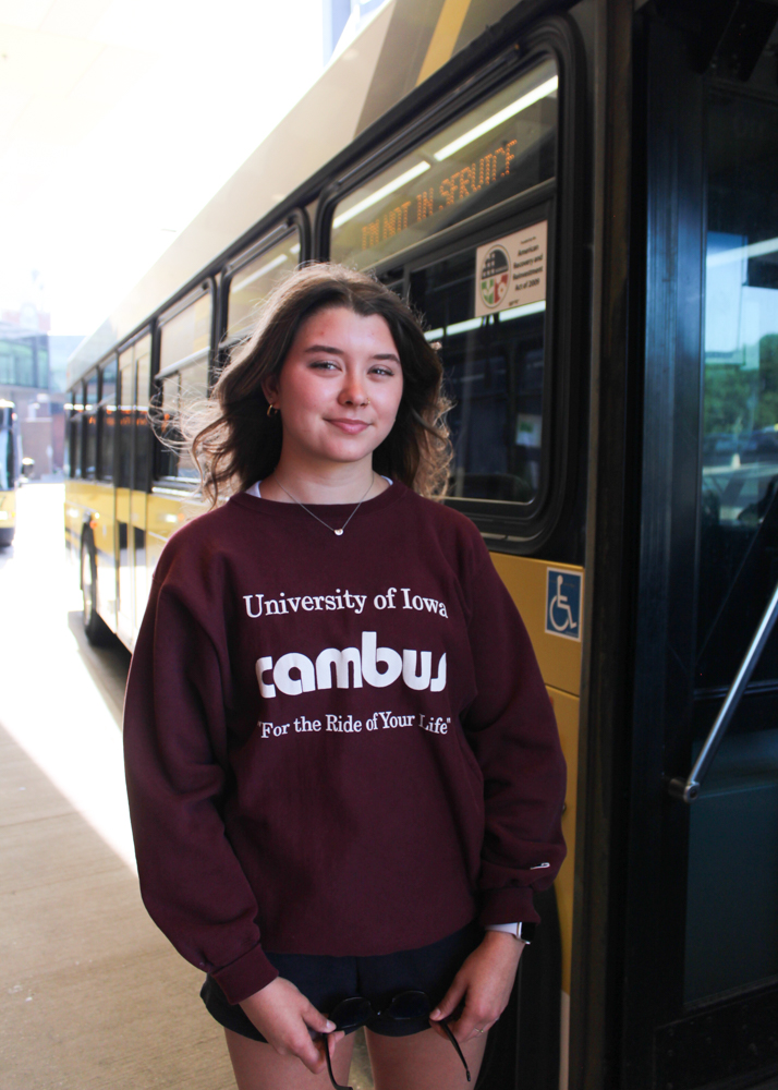 A portrait of Driver of The Year Isabella Newell standing alongside a CAMBUS