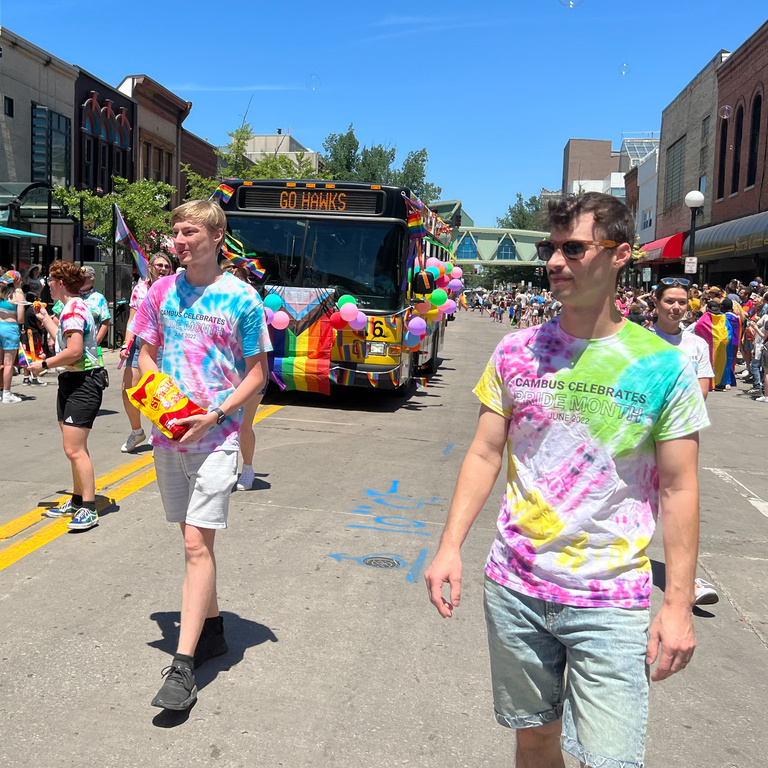 student employees walking in front of CAMBUS for the pride parade