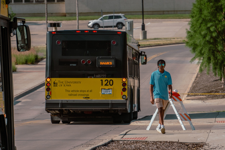 A CAMBUS student driver passes by a bus as it navigates an obstacle