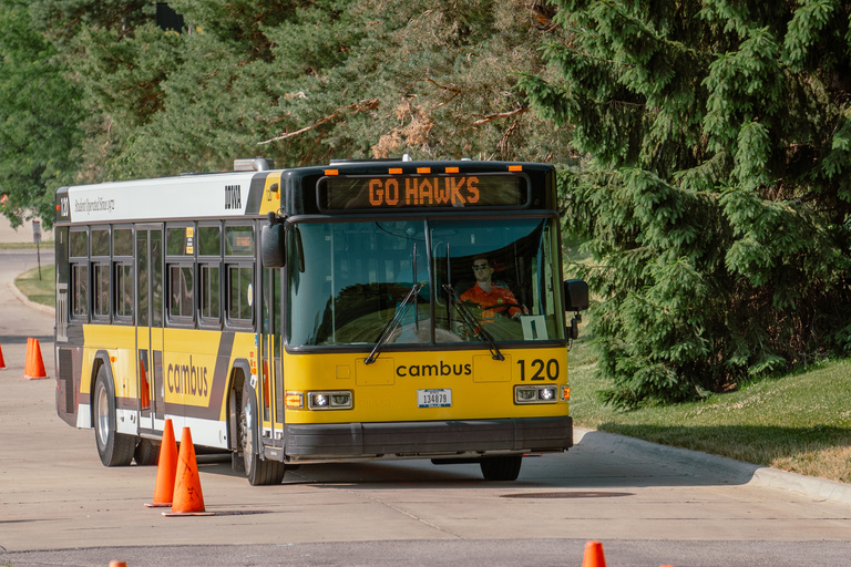 A bus navigates cones at the 2023 IPTA state bus roadeo