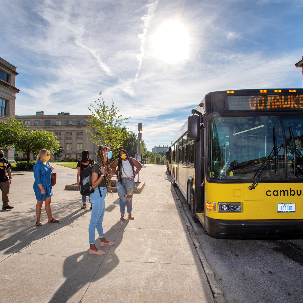 CAMBUS pictured at Macbride Hall with riders waiting to board the bus.