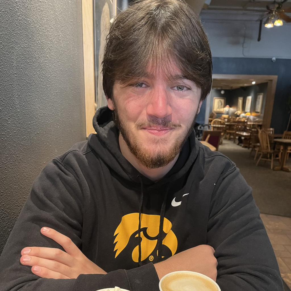 CAMBUS trainer Cameron McKnight smiles in front of a Java House latte