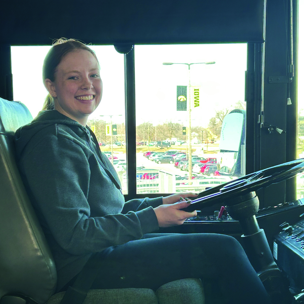 Student cambus driver Rachel Woodley posing on bus.