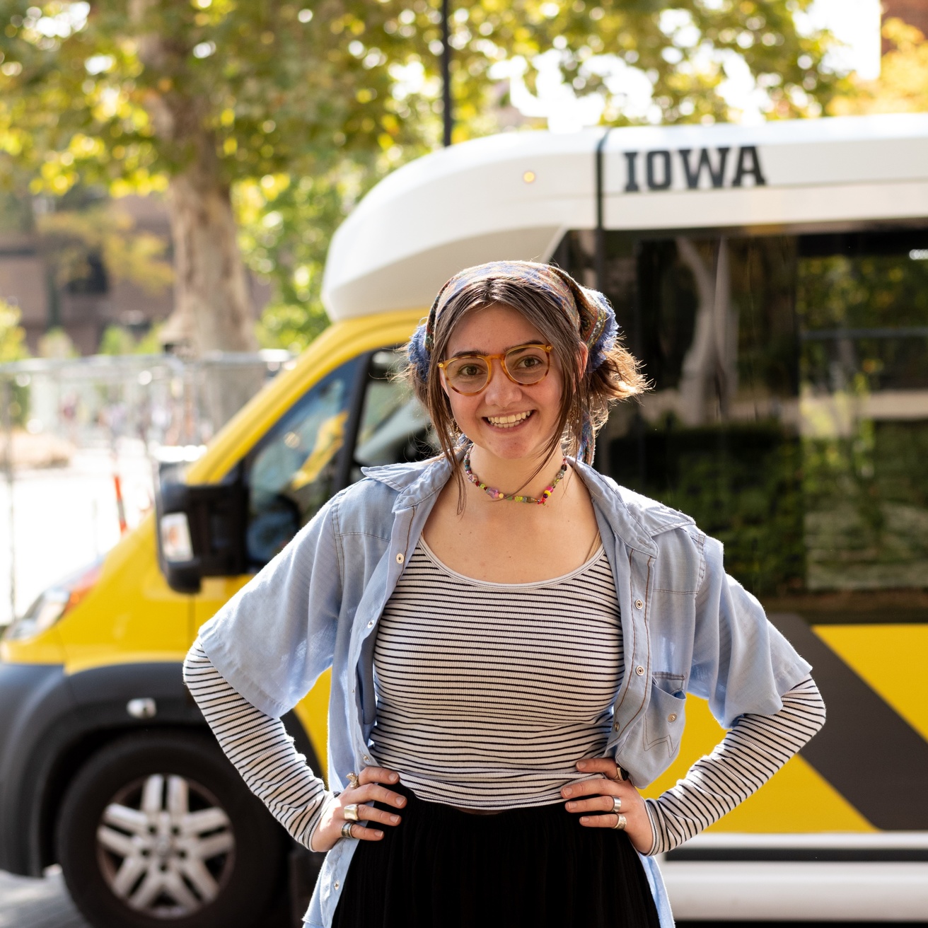 A photo of a CAMBUS driver in front of a mini bus