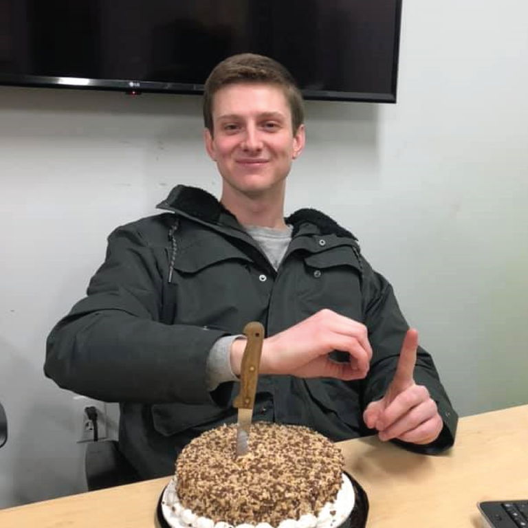 Sean Stevens sits with a cake
