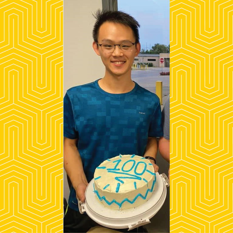 Student mechanic Chen-You Wu poses for a photo with a cake