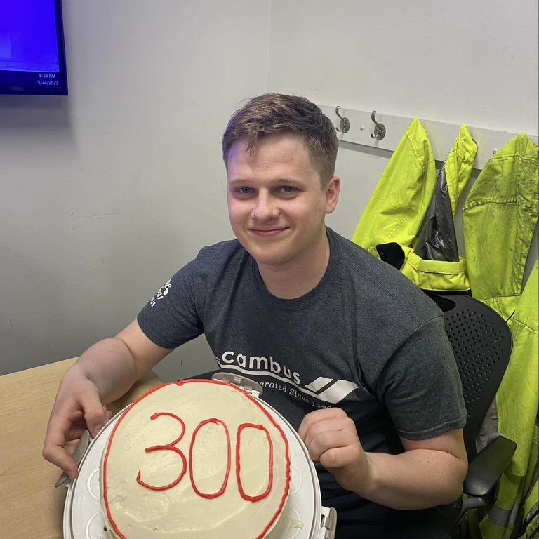 dispatcher Luke poses with a cake