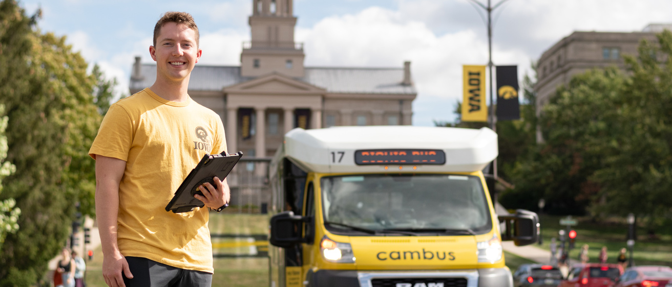 Driver standing with bionic bus in front of old capitol building
