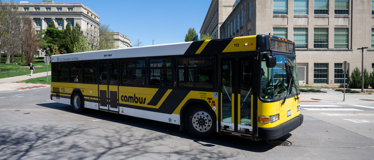 a photo of a CAMBUS driving past the Pentacrest.