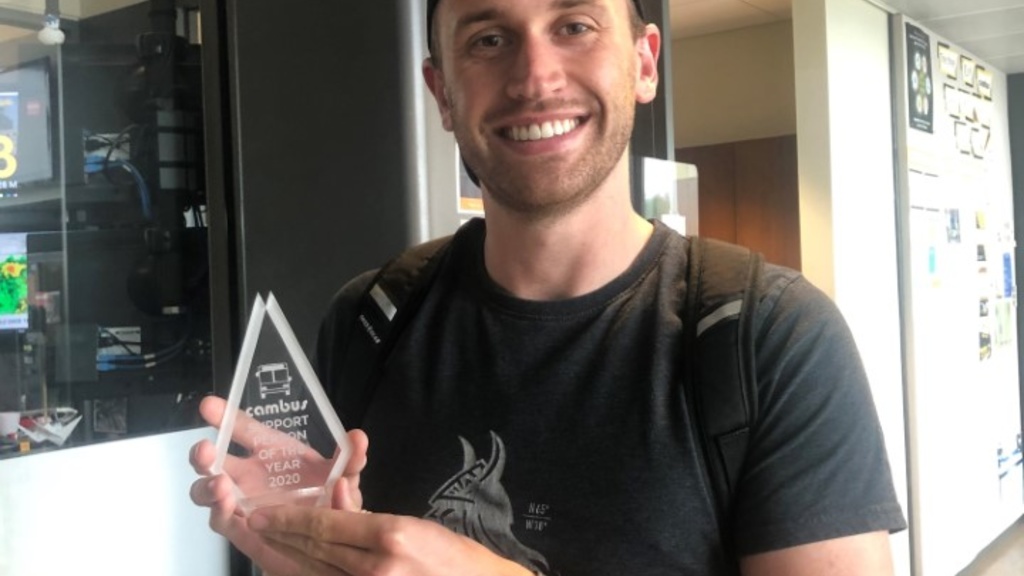 Tristan Freese holding Support Person of the Year Award