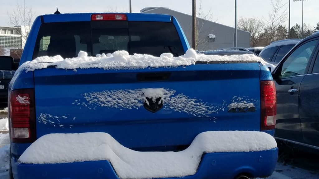 image of vehicle with snow blocking the license plate