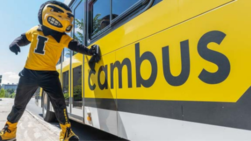 Herky washes the side of a CAMBUS