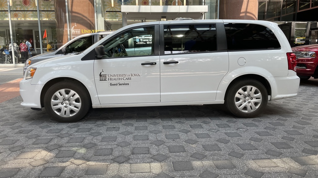 white minivan parked in front of main lobby with Iowa Guest Services decal on door