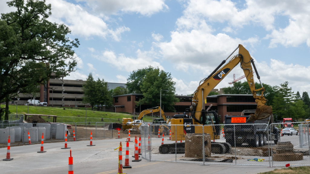 image of construction equipment on road with traffic cones separating traffic