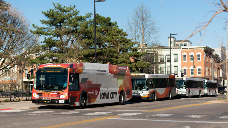 City buses at bus stop on Clinton Street